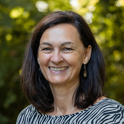 Mitarbeiterfoto vor grünem Hintergrund